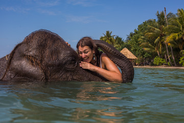 Girl swims with the elephant
