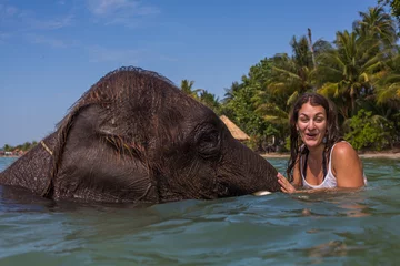 Fotobehang Girl swims with the elephant © kitkorzun