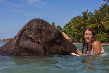 Girl swims with the elephant
