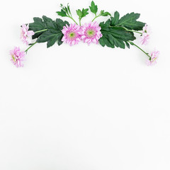 Floral frame with pink flowers and green leaves on white background. Flat lay, top view.