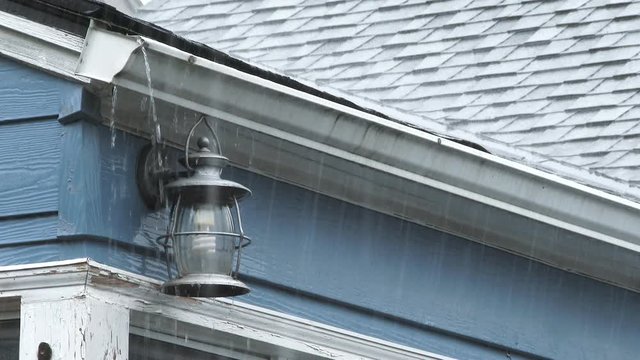 Heavy rain causes gutters to back up and overflow during rain storm in Portland, Oregon.