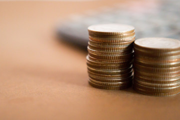 Coins on wooden table calculator background, Concept Business and financial