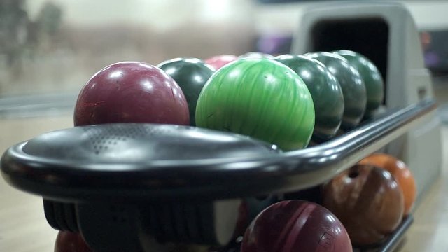 Multicolored Balls for Bowling Colored balls for bowling lie on the stand. The atmosphere of the bowling club