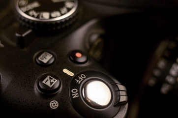 Close-up macro shot of a modern digital SLR camera. Detailed photo of black camera body with...
