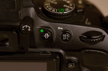 Close-up macro shot of a modern digital SLR camera. Detailed photo of black camera body with...