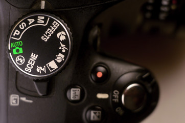 Close-up macro shot of a modern digital SLR camera. Detailed photo of black camera body with...