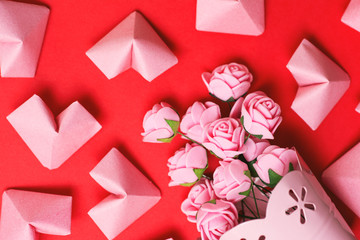 pink roses and paper hearts on red background. space for text, Happy Valentine's Day card 