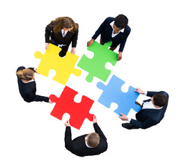 Businesspeople Solving Jigsaw Puzzle