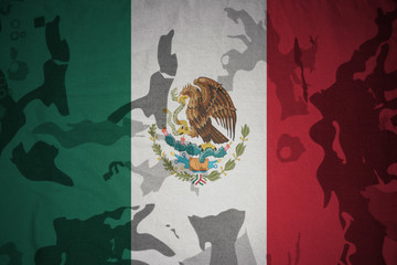 flag of mexico on the khaki texture . military concept