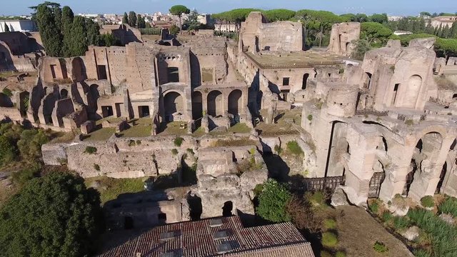 Aerial bird view Italy Rome flying close up Domus Severiana moving left to right extension to imperial palaces Palatine Hill in Roma popular tourist attraction in large and beautiful city center 4k