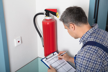 Professional Checking A Fire Extinguisher
