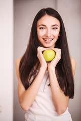 Diet. A young woman watches her figure and eating fresh fruit. The concept of healthy eating.