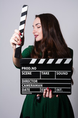 Portrait woman holding a movie clapper