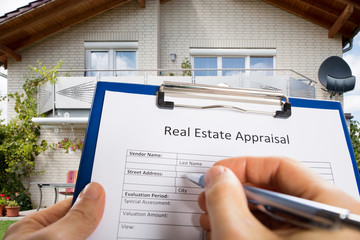 Person Hand Filling Real Estate Appraisal Document - obrazy, fototapety, plakaty