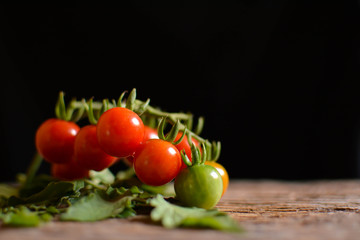 Stil life group of tomato on old wood and black background