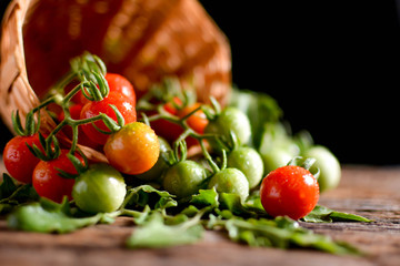 Still life group of tomato in basket on old wood