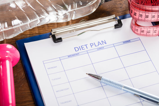 Diet Plan With Dumbbell, Water Bottle And Measuring Tape