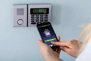 Person Arming The System With Remote Controller