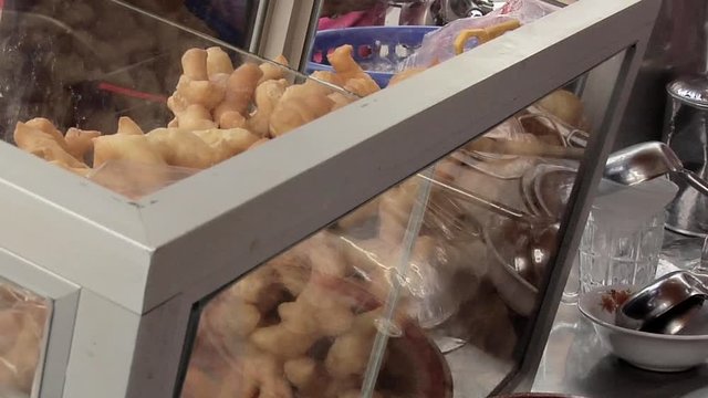 Patongkho (Chinese Cruller) at a Soy Milk Vendor at the Market in the Center of Town in New Suthothai 