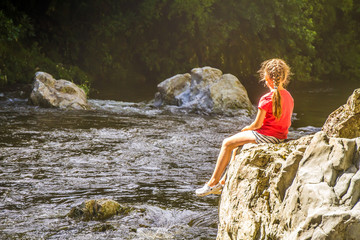 beautiful river in forest, child girl at weekend forest walk