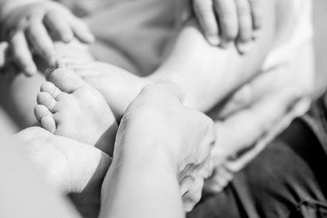 tiny baby feet in mother's hands