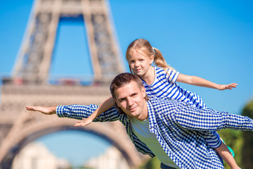 Fototapeta na wymiar Happy family in Paris near Eiffel Tower during summer french vacation