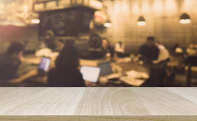 Wood table top and blurred bokeh cafe and coffee shop interior 