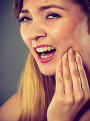 Woman suffering from tooth pain