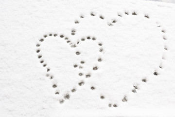 Shapes of heart on snow