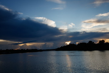Fototapeta premium Overcast rain cloud it's going to rain at river in evening