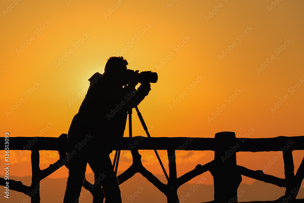 Wall mural silhouette photographer with sunset 