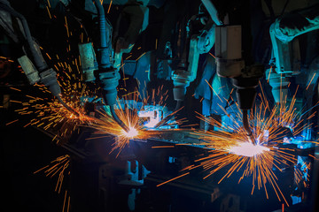 Team robots are welding assembly car part in car factory