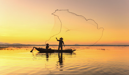 Fishermen fishing in the early morning golden light 