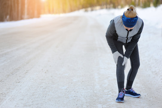 Injuries - Sports Running Knee Injury On Woman. Winter Marathon.