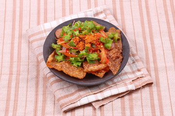 Spicy sour wing bean salad  with crispy pork served .