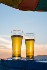 Glass of beer on a sunset