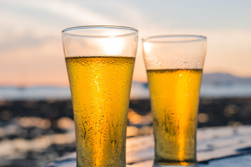 Glass of beer on a sunset