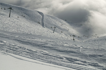 Ski slopes in the clouds on southern slope Aibga Ridge of Western Caucasus at Rosa Khutor Alpine Resort