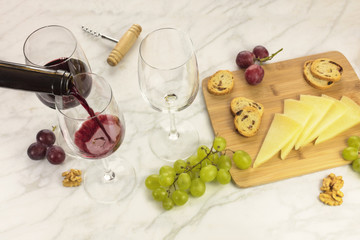 Red wine, cheese, bread and grapes at tasting
