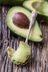 Avocado. Cut avocado on a oak wood background table. Selective focus.