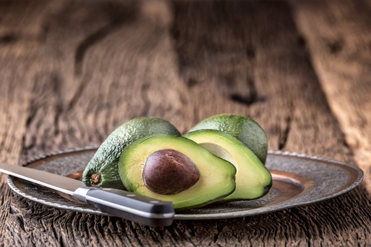 Avocado. Cut avocado on a oak wood background table. Selective focus.