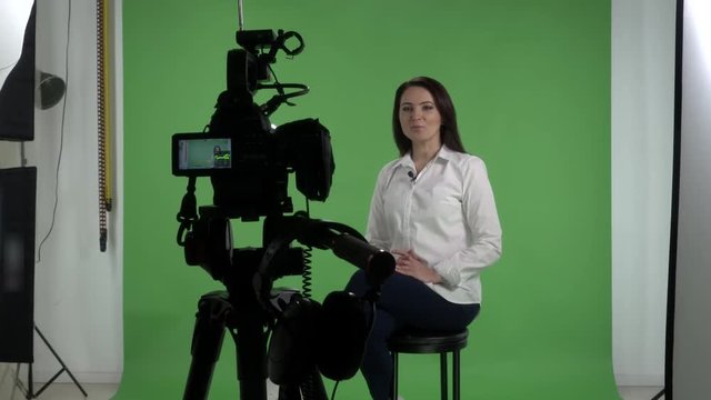  Backstage recording interview in green screen studio woman talking in front of camera