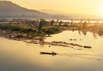 Foto auf Acrylglas wooden fishing boat sailing in mekong river on sunrise at khongjiam district of thailand border of thailand and laos  © Soonthorn