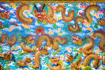 Close up of Gold Chinese dragon on the wall of temple, Chinese temple