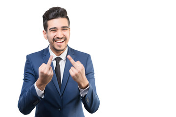 Young attractive man in a blue suit showing middle fingers on a white background. Isolated
