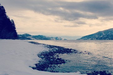 Winter lake shore line and mountains