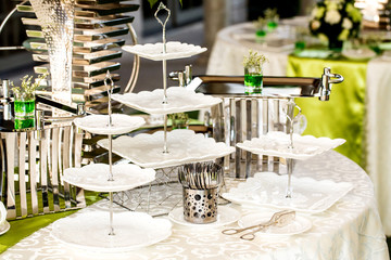 Ceramic white plate stacked on table for party in shady garden