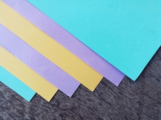 Colorful office stationary paper on wooden table, abstract and vintage/pastel background