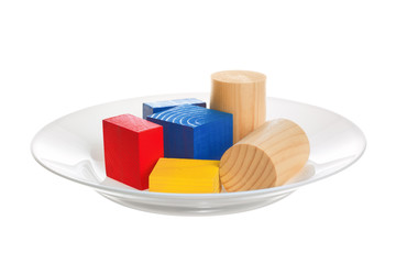 Genetically modified food. Plate with colored objects on a white
