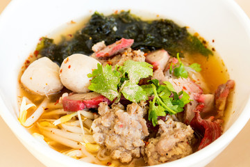 Red pork noodles with flavouring closeup